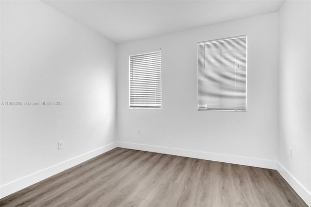 spare room featuring wood-type flooring