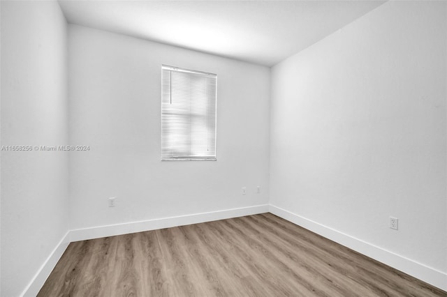 spare room with wood-type flooring