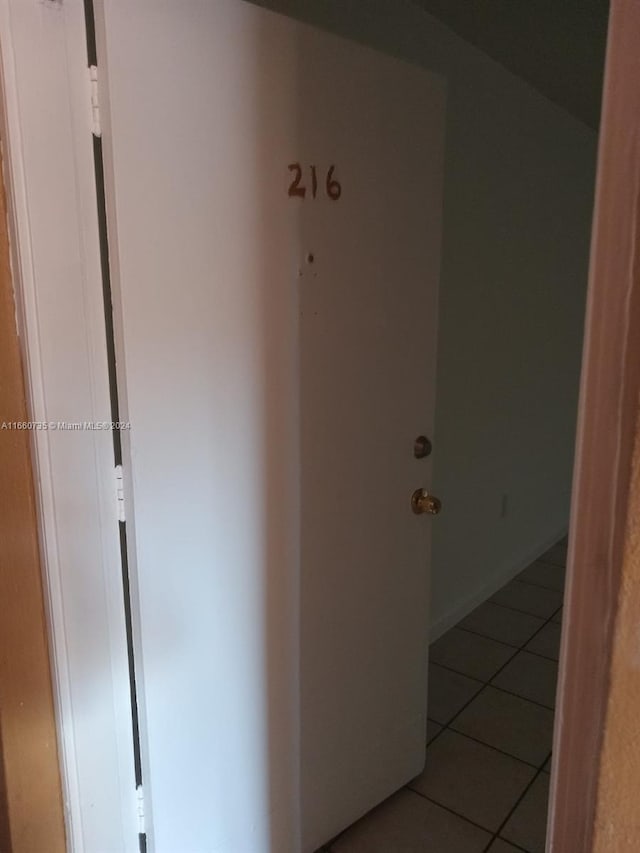 corridor with light tile patterned flooring