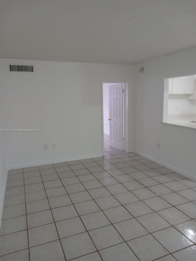 1230 W 54th St Unit 216A, Hialeah, FL 33012 - unfurnished room with light tile patterned floors and baseboards