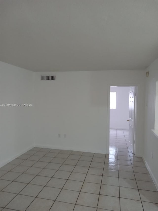 empty room with light tile patterned flooring