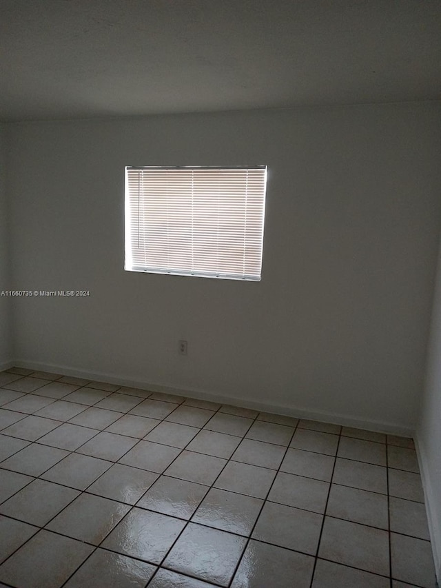 1230 W 54th St Unit 216A, Hialeah, FL 33012 - unfurnished room featuring light tile patterned floors and baseboards