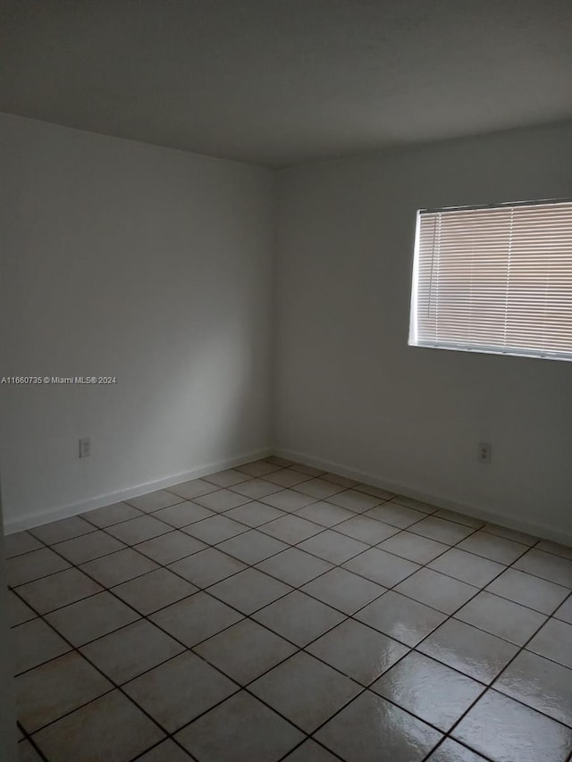 empty room with light tile patterned floors