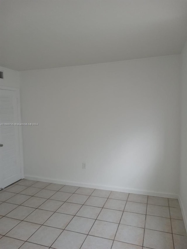 empty room with light tile patterned floors