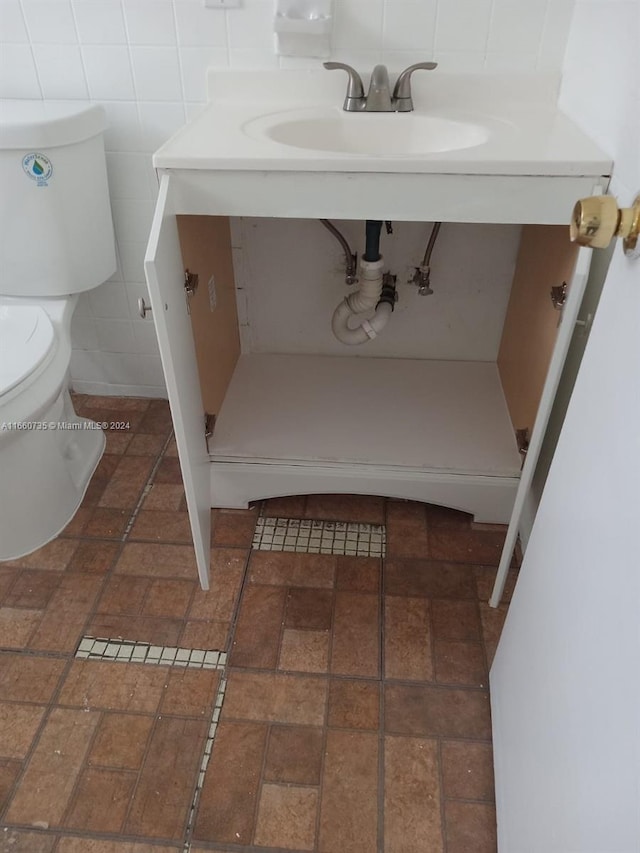 bathroom with tile walls and toilet