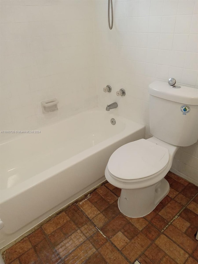 bathroom with shower / bathtub combination and toilet