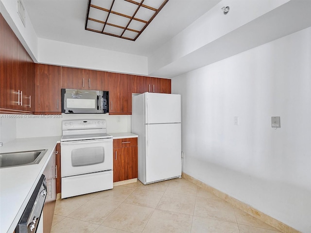 kitchen featuring light tile patterned flooring, sink, and white appliances