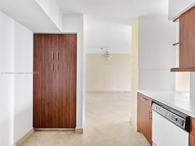 kitchen featuring dishwasher, light tile patterned floors, and decorative light fixtures