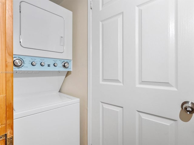 washroom with stacked washing maching and dryer