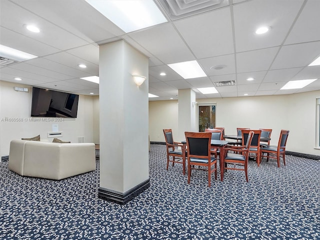 dining room with a drop ceiling and carpet flooring