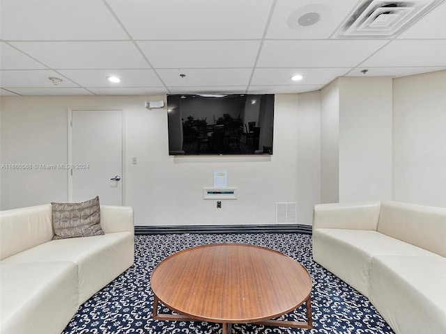 living room with a paneled ceiling