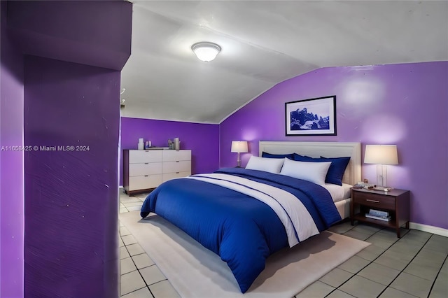 bedroom featuring light tile patterned flooring and lofted ceiling