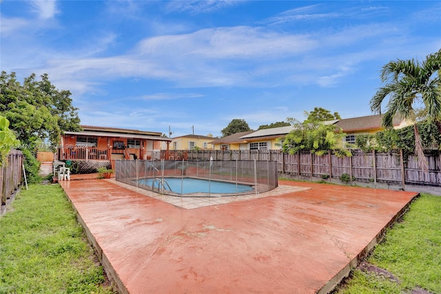 view of pool featuring a wooden deck and a yard