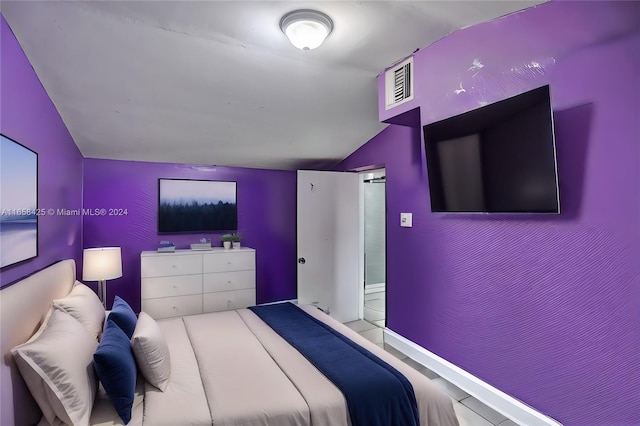 bedroom featuring lofted ceiling and tile patterned floors