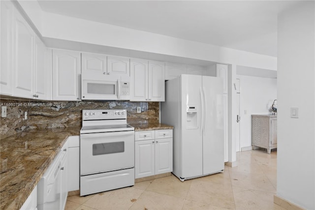 kitchen with dark stone counters, white cabinets, white appliances, backsplash, and light tile patterned floors