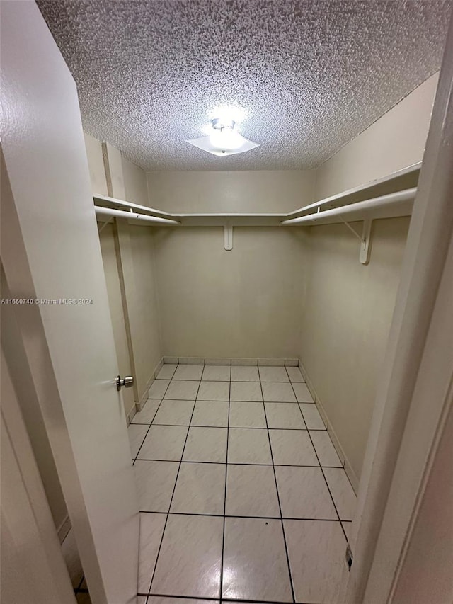 spacious closet featuring light tile patterned flooring