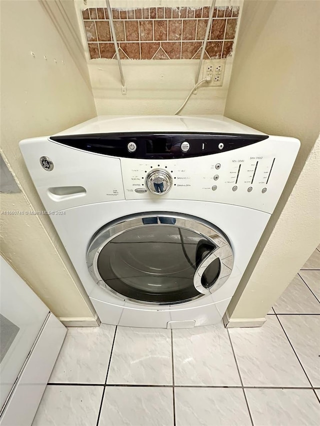 laundry area with washer / dryer and tile patterned floors