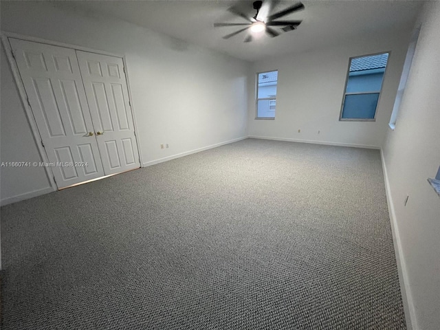 carpeted spare room with ceiling fan