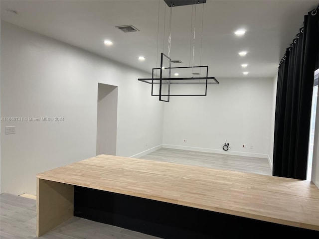 unfurnished dining area with light wood-type flooring