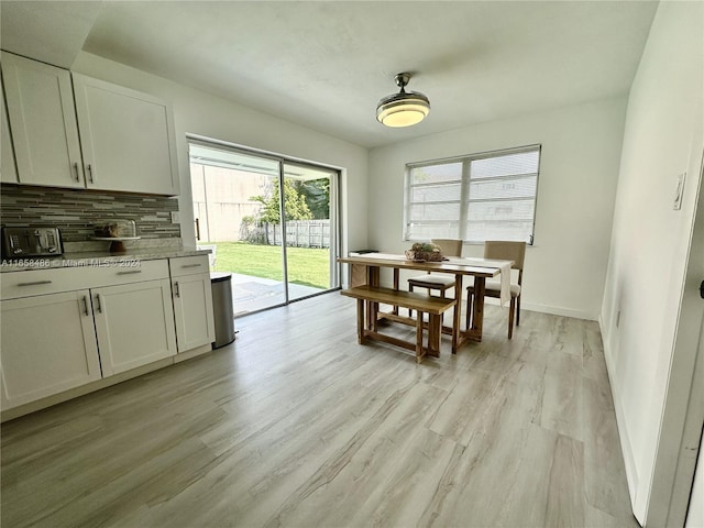 dining space featuring light wood-type flooring