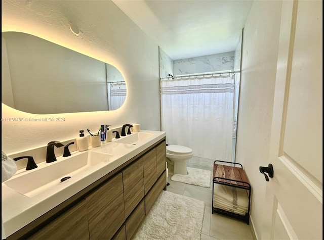 bathroom featuring vanity, a shower with shower curtain, tile patterned flooring, and toilet