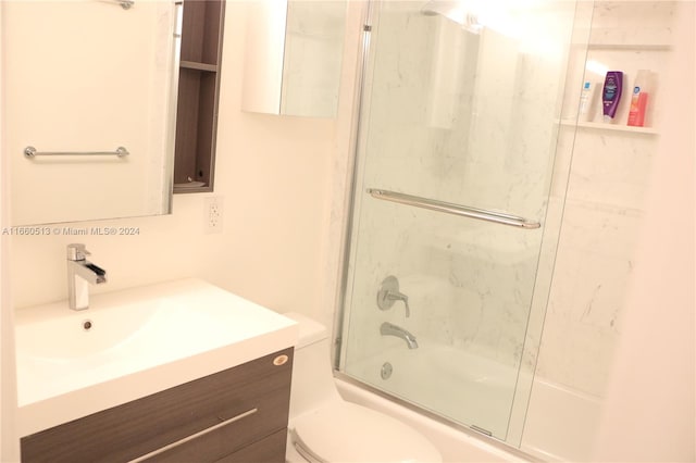 full bathroom featuring toilet, vanity, and combined bath / shower with glass door