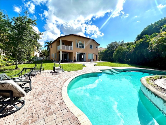 view of pool featuring a yard and a patio area