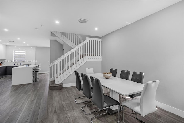 dining room featuring sink and dark wood-type flooring