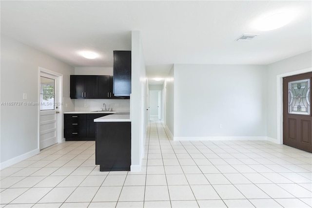 kitchen with backsplash, sink, and light tile patterned floors