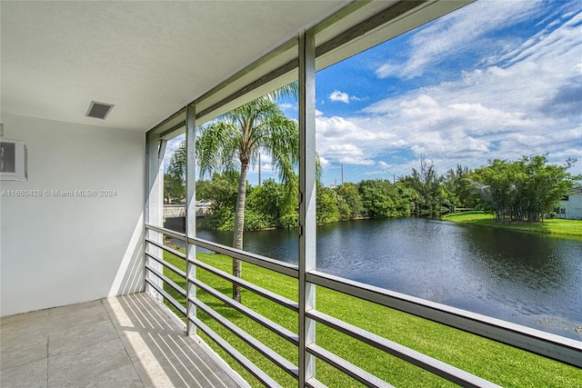 unfurnished sunroom featuring a water view