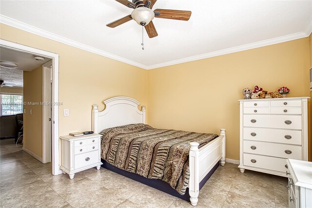 bedroom with ceiling fan, a textured ceiling, and ornamental molding