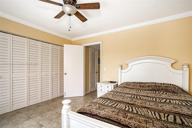 bedroom with a textured ceiling, ornamental molding, ceiling fan, and a closet