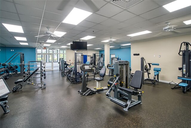 gym with a drop ceiling and ceiling fan