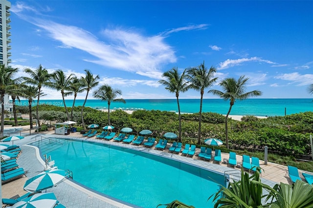 view of pool with a patio and a water view