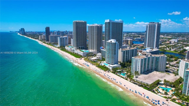 birds eye view of property featuring a view of the beach and a water view