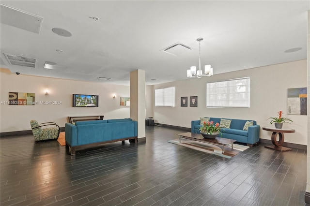 interior space with an inviting chandelier, dark wood-type flooring, and multiple windows