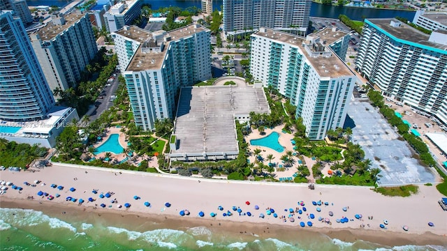 drone / aerial view featuring a view of the beach and a water view