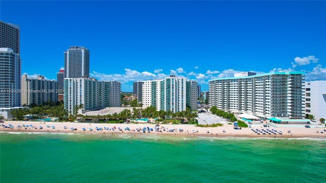 birds eye view of property with a water view and a view of the beach