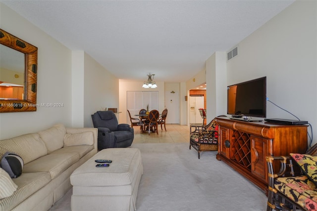 carpeted living room featuring a chandelier