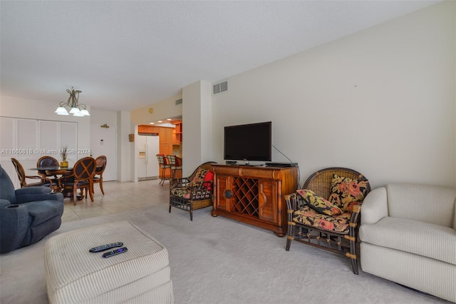 carpeted living room with a notable chandelier