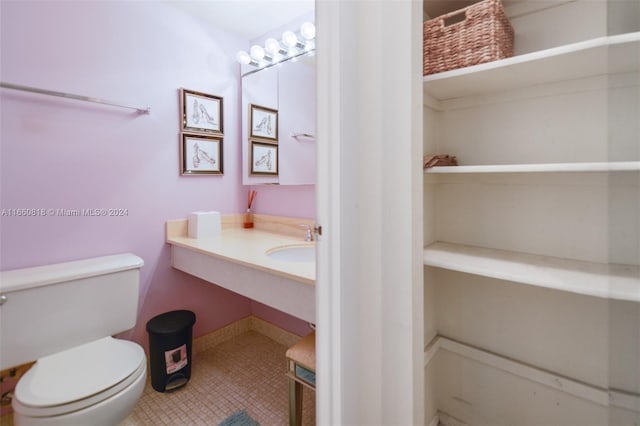 bathroom featuring sink, toilet, and tile patterned floors