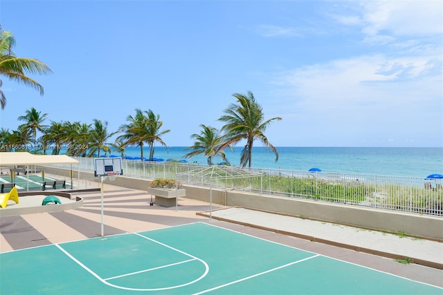 view of home's community with a water view and basketball hoop