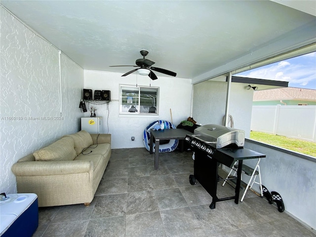 sunroom featuring ceiling fan