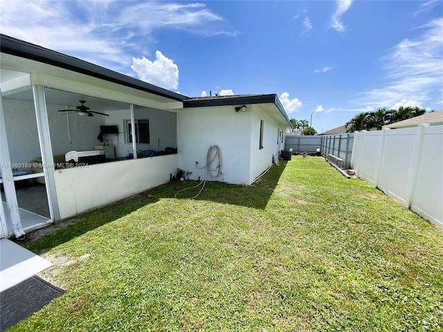 view of yard featuring cooling unit and ceiling fan