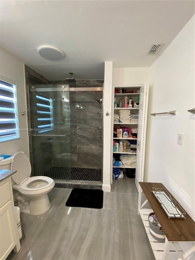 bathroom with a shower with door, toilet, vanity, and hardwood / wood-style flooring