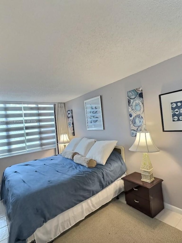 carpeted bedroom featuring a textured ceiling