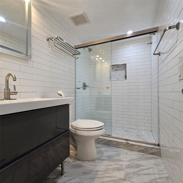 bathroom with toilet, an enclosed shower, vanity, and tile walls