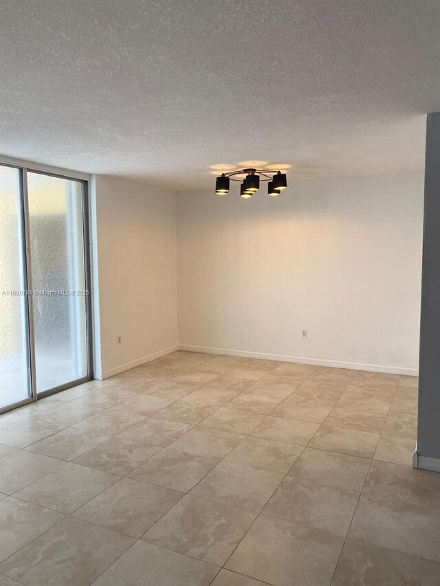 unfurnished room featuring a textured ceiling