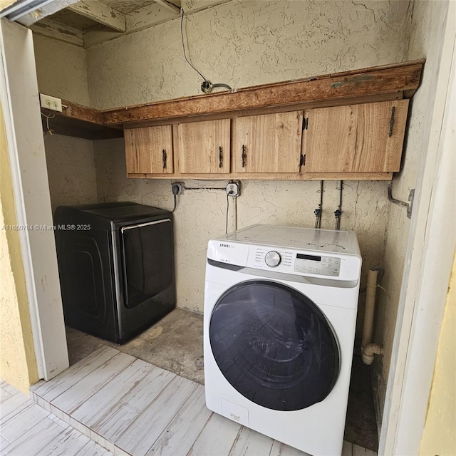 laundry room with cabinet space and washer / clothes dryer