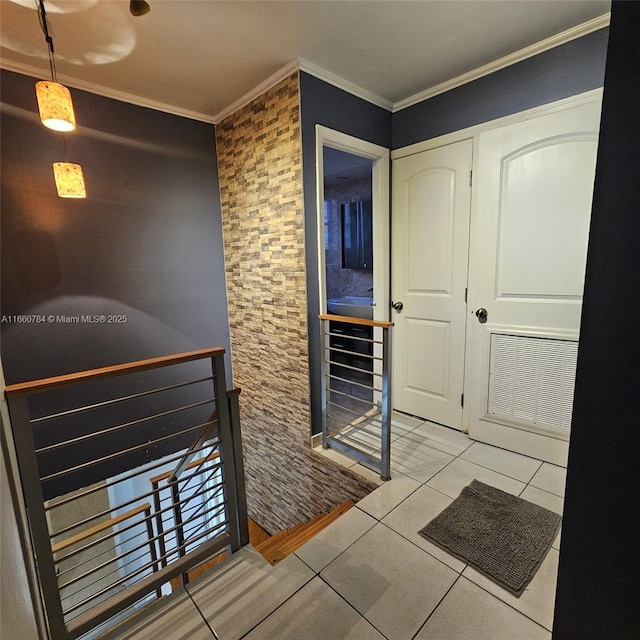 corridor with visible vents, tile patterned flooring, an upstairs landing, and crown molding